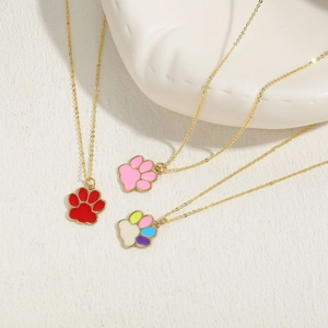 Detailed view of colorful cat paw enamel pendants on gold chains for women
