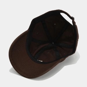 Detailed interior of dark brown cotton baseball cap showing black sweatband and metal buckle