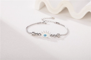 Detail of beaded evil eye bracelet with blue pupil charm and adjustable chain