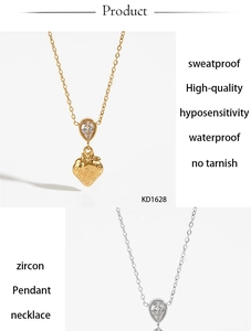 Detail view of strawberry pendant with sparkling zircon in gold and silver finishes