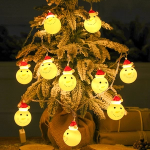 Christmas snowman LED string lights hanging on a Christmas tree with a warm yellow glow