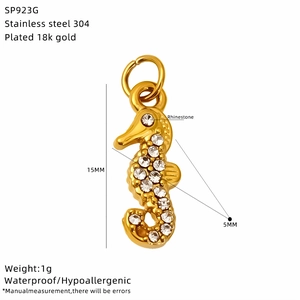Detailed view of an 18k gold plated seahorse pendant with rhinestones and size markings
