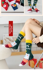 Detail of Christmas crew socks with cartoon Santa and polar bear patterns in a gift box