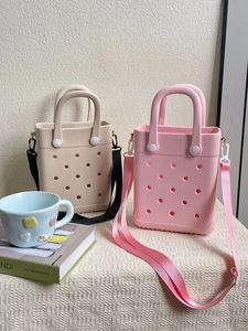 Detail of beige and pink EVA hollow tote bags with adjustable straps and round vents