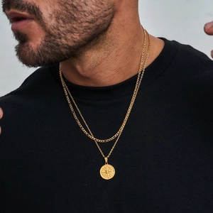 Men's gold double-layer necklace with compass pendant and Figaro chain on neck