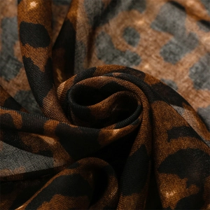 Macro view of brown leopard print scarf fabric showing cotton-linen texture and details