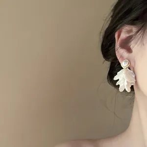 Detail of floral petal tassel earrings with pearls on a model in vintage French style