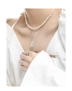 Close-up of S925 silver necklace with rectangular pearl pendant and matching pearl ring