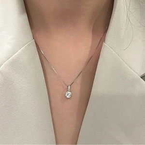 Elegant silver necklace with sparkling solitaire zircon pendant worn on a model