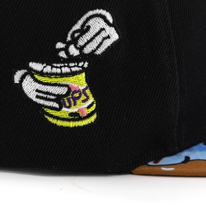 Macro detail of high-quality UPS embroidery on a black cotton twill baseball cap
