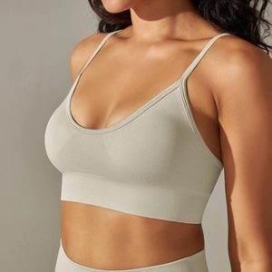 Detail of light grey seamless knitted sports bra featuring thin straps and ribbed band