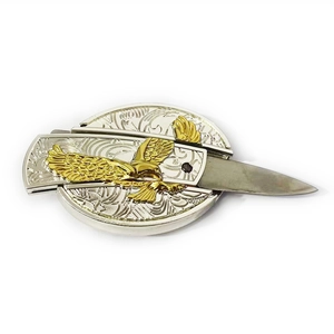 Western eagle belt buckle with hidden folding knife featuring golden eagle relief carving