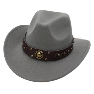 Detail of grey felt cowboy hat featuring a leather band with rivets and horseshoe badge
