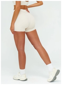 Macro detail of high-waist yoga shorts showing V-shape stitching and lift effect