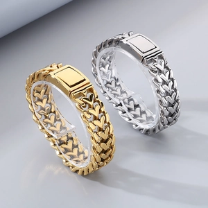 Detailed close-up of heart-shaped link bracelets in gold and silver with metal clasps