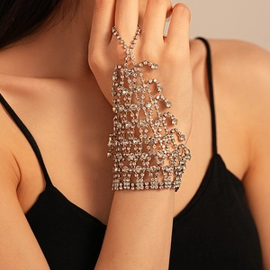 Macro detail of luxury silver mesh hand chain bracelet with sparkling rhinestone fringes