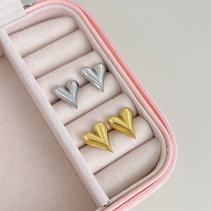 Exaggerated 3D heart stud earrings in polished gold and silver steel finishes