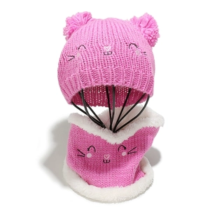 Detail of pink knitted hat with cat ears and fleece-lined neck warmer for children