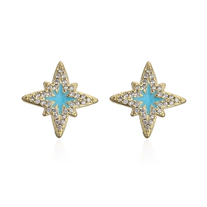 Close-up of star-shaped 18K gold plated earrings with blue enamel and clear zircon