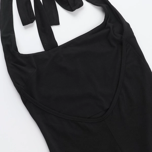 Detail of black halter neck jumpsuit featuring an open back design and slim fit cut