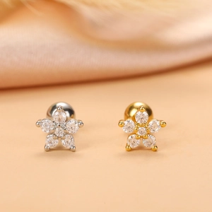 Detail of silver and gold flower stud earrings with shimmering clear cubic zirconia