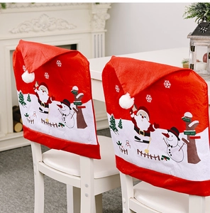 Detail of Christmas chair covers with Santa and Snowman appliques in cozy home setting