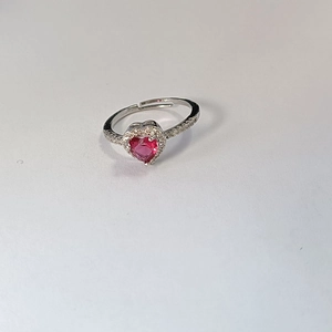 Close-up of heart-shaped red gemstone ring with micro-pave diamonds and open band