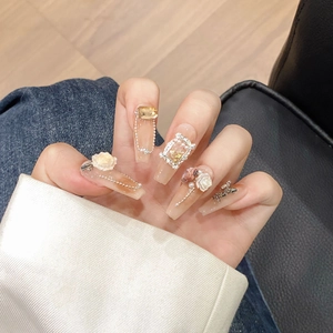 Handmade press-on nails featuring white camellias, pearls, and chains in long trapezoid shape