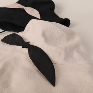 Detailed texture of cotton linen sun hats featuring elegant large decorative bowknots