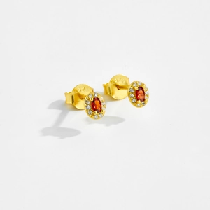 Detail view of oval ruby red earrings with gold S925 silver and cubic zirconia accents