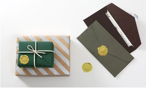 Detail of vintage gold wax seal stickers with 3D floral relief and Best Quality text