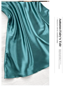 Close-up of dark green satin sleepwear showing smooth texture and elegant drape