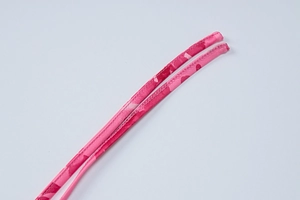 Detailed macro view of pink camouflage printed fabric straps with fine stitching