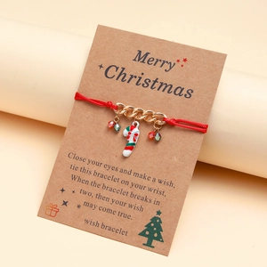 Handmade red Christmas candy cane wish bracelet on a brown kraft card gift package