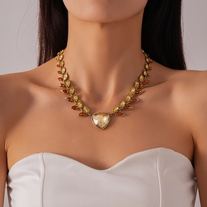 Detailed shot of vintage gold wheat drop necklace with champagne triangular crystals