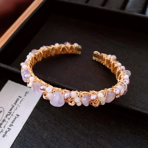 Detailed close-up of 18K gold-plated wire-wrapped bangle with amethyst and pearls