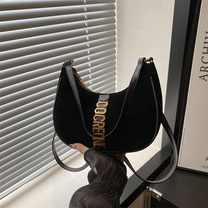 Suede and leather black half-moon hobo bag with gold vertical metal hardware detail