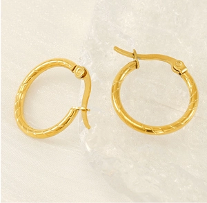 Detailed view of gold-plated stainless steel hoop earrings with spiral rope texture design