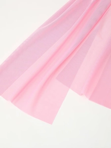 Detailed close-up of soft pink tulle fabric mesh with delicate texture and layered folds