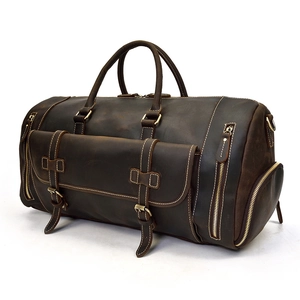 Detail of vintage dark brown leather duffle bag with outer pocket and side zipper