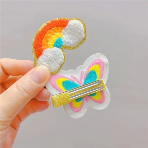 Detailed embroidery of rainbow cloud and butterfly plush hair clips for girls