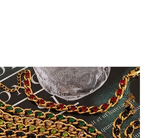Macro detail of gold-plated chain bracelet set with colorful geometric gemstones