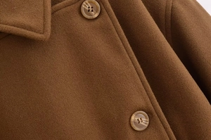 Macro shot of brown wool coat fabric texture and marble buttons on the lapel jacket