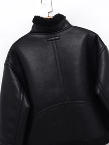 Detail of black faux leather jacket back featuring premium stitching and fleece collar