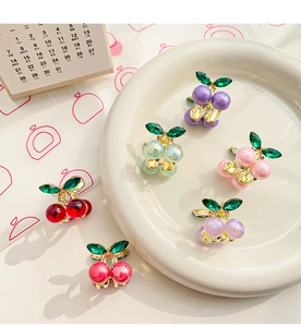 Macro view of mini cherry alloy hair clips with colorful pearls and crystal leaves