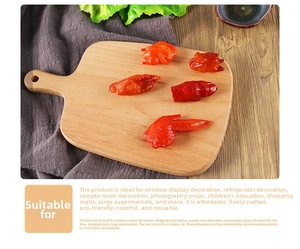 Detailed realistic resin food models of roasted chicken wings and feet on wooden board