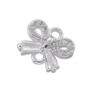 Macro shot of bow-shaped pendant with sparkling zircon inlays for DIY jewelry making