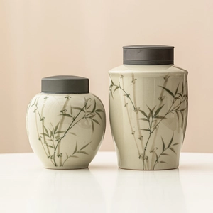 Elegant white ceramic tea canisters with green bamboo patterns and black alloy lids