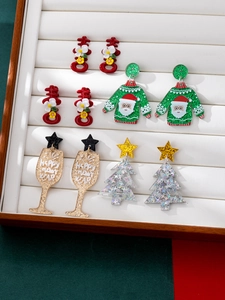 Detail view of acrylic Christmas earrings with glitter patterns in a velvet jewelry box