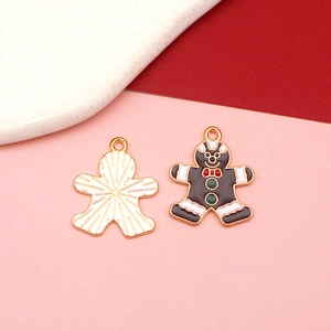 Detail of gingerbread man charms with brown enamel front and gold textured back